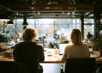 Coworking space with professionals working on laptops, showcasing community and shared amenities