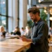 BOI Report for LLC- US LLCs Are Now Exempt and What to Know in 2026 | Alliance Virtual Offices Professional using his phone in a modern coworking space, an on-demand alternative to a traditional office