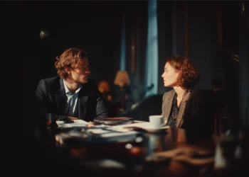 Lawyer and client reviewing case documents in a private meeting room during a deposition preparation session