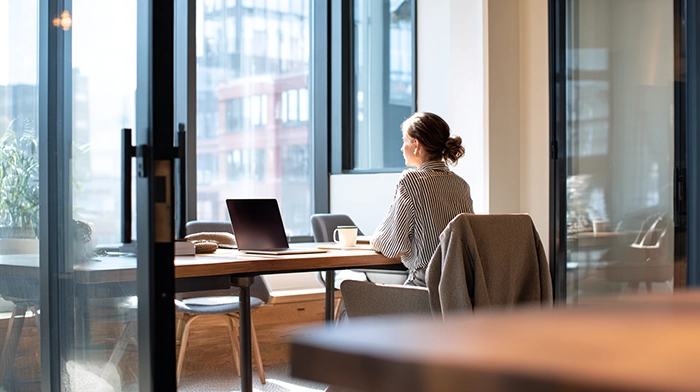 Registered Agent vs Virtual Office Address What LLC Owners Need to Know | Alliance Virtual Offices LLC owner working remotely from a modern virtual office space, considering registered agent and business address options