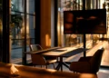 Professional meeting room with conference table, modern chairs, large presentation screen, and floor-to-ceiling windows at golden hour, ideal for interview room rental