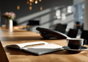 Reception desk setup with office phone, illustrating AI vs live receptionist options for small business