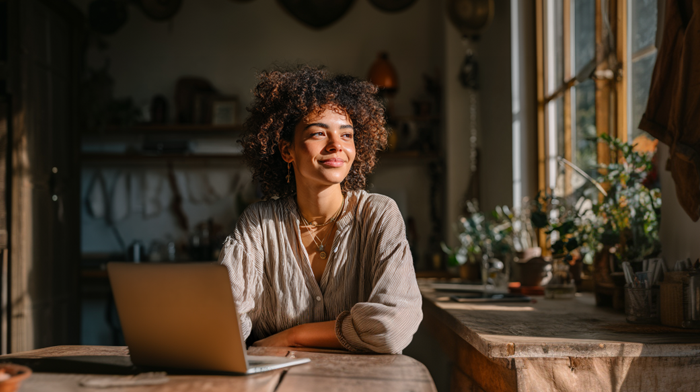 Build Your Professional Wellness Business Online- Life Coaches Guide to a Legit Presence Without a Physical Office | Alliance Virtual Offices Life coach working remotely from home on laptop in warm natural light setting