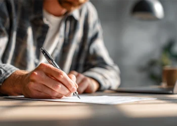 Business owner completing LLC filing paperwork in home office
