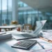 Home Office Deduction vs Virtual Office- Which Saves You More at Tax Time | Alliance Virtual Offices Close-up of a professional desk with a calculator, stacked documents, laptop, and financial charts in a bright modern office.