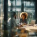 Meeting Room Rental Pricing in 2026- What You Need to Know | Alliance Virtual Offices Three professionals having a meeting in a modern glass-walled conference room, representing meeting room rental options for businesses.