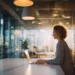 On-Demand Meeting Rooms for Hybrid Teams- Client-Ready Spaces Without a Lease | Alliance Virtual Offices Professional working on a laptop in a client-ready meeting room with floor-to-ceiling glass walls