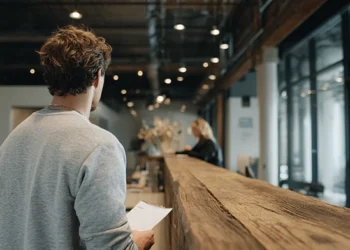 Man checking in at a modern virtual office reception desk