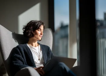 Healthcare professional relaxing in modern office chair by sunny window, running a private practice without a traditional clinical lease using a virtual office