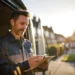 Answering Service for Plumbers HVAC Contractors | Alliance Virtual Offices Contractor checking a tablet beside his work van on a residential street at golden hour
