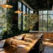 Coworking Spaces for Startups- The 2026 Guide for Early-Stage Founders | Alliance Virtual Offices Sunlit coworking space with a long wooden shared table, laptops, pendant lights, lush greenery, and floor-to-ceiling windows