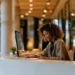 Medical Office Answering Service- A Complete Guide for Healthcare Practices | Alliance Virtual Offices Live receptionist in a headset taking notes while answering calls at a modern front desk