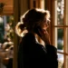 Second Phone Number for Business- How to Get a Separate Line Without a New Device | Alliance Virtual Offices Woman standing by a sunlit window taking a business call on her cell phone at home