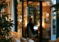 Chicago virtual office user working alone in a glass phone booth pod at a modern workspace