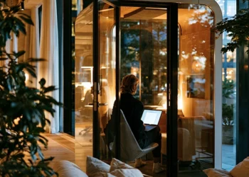 Chicago virtual office user working alone in a glass phone booth pod at a modern workspace