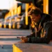 Freight Broker vs Freight Forwarder vs Dispatcher vs 3PL- Key Differences Explained | Alliance Virtual Offices Logistics professional reviewing freight loads on a tablet beside a row of trucks at golden hour