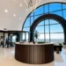 Answering-Service-Chicago-What-It-Costs--How-to-Choose | Alliance Virtual Offices Modern office lobby with a round reception desk and panoramic arched windows