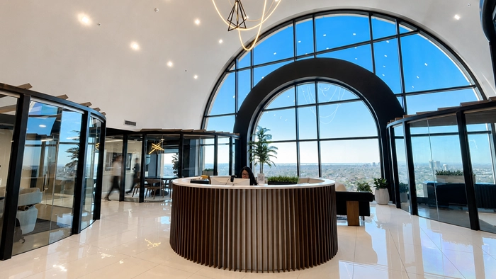 Answering-Service-Chicago-What-It-Costs--How-to-Choose | Alliance Virtual Offices Modern office lobby with a round reception desk and panoramic arched windows
