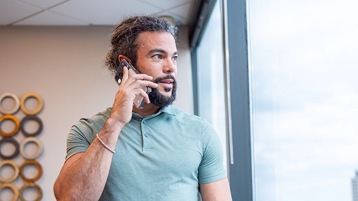 Best Answering Services for Small Businesses | Alliance Virtual Offices Small business owner taking a client call by the window in a private office