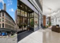 Three views of 50 Franklin: the historic corner building exterior, the street-level entrance, and the interior lobby reception desk