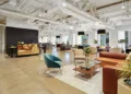 Coworking lounge with sofas, armchairs, and large windows in a modern office building