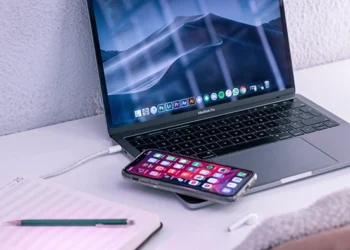 Remote work setup with a laptop, smartphone and notebook on a minimalist desk