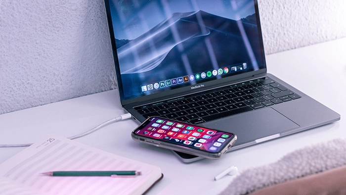 Best Google Voice Alternatives for Business Free Paid 2026 | Alliance Virtual Offices Remote work setup with a laptop, smartphone and notebook on a minimalist desk